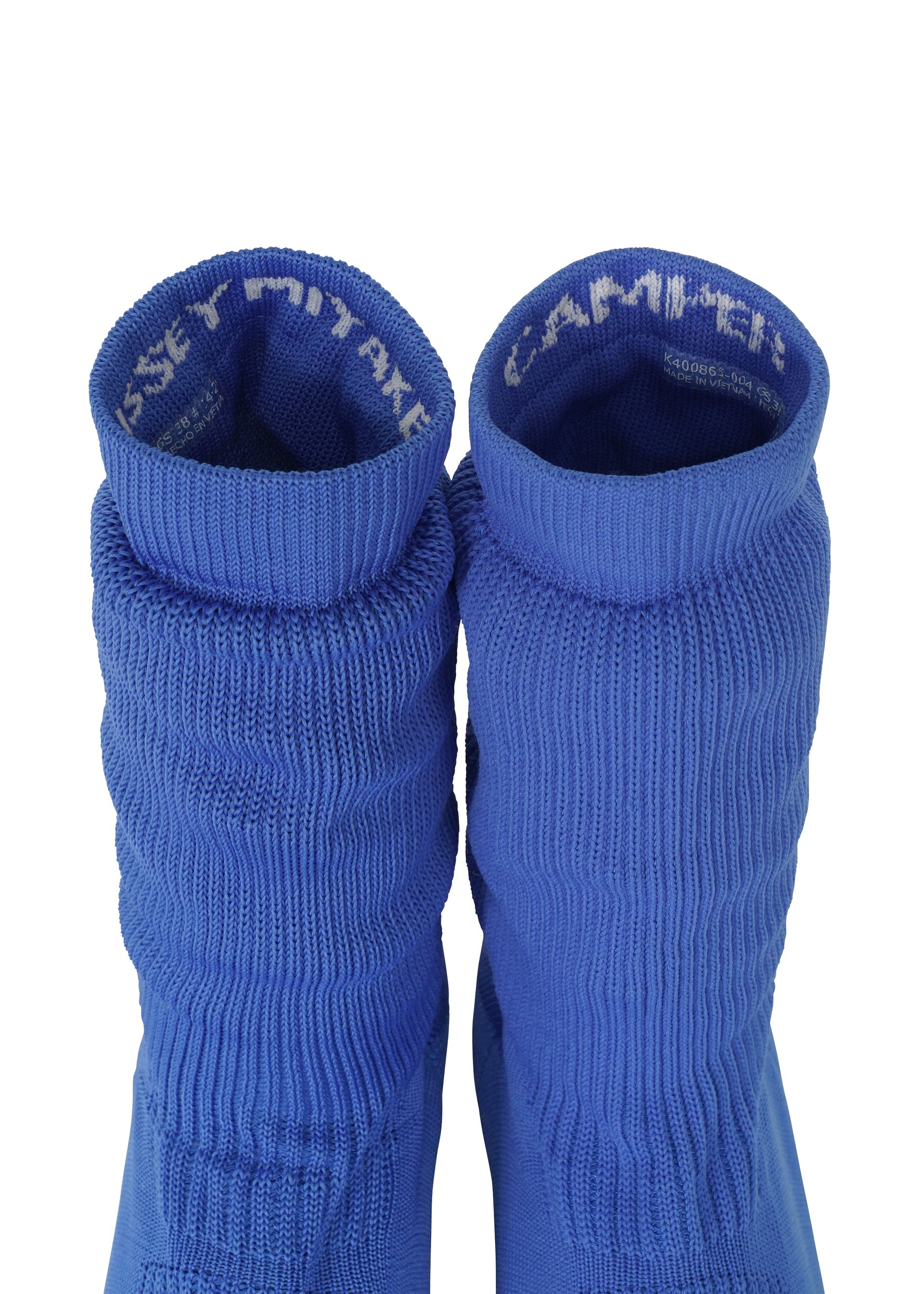 Zoomed view Two blue ribbed knit socks from ISSEY MIYAKE’s ANNA collection are positioned side by side, viewed from above. Reminiscent of stylish knitted footwear, the inside cuffs display partially visible white text. The background is plain white.