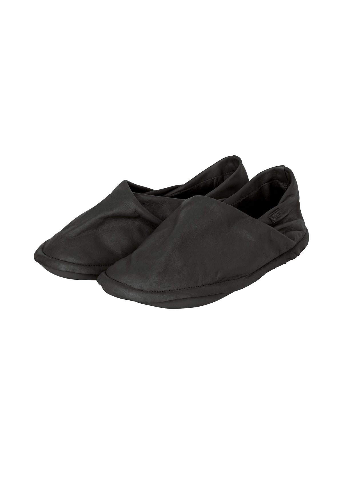 Zoomed view A pair of minimalist black slip-on shoes crafted from soft material, set against a plain white background—these are the PEU FORM shoes by ISSEY MIYAKE. - BLACK （no.15）