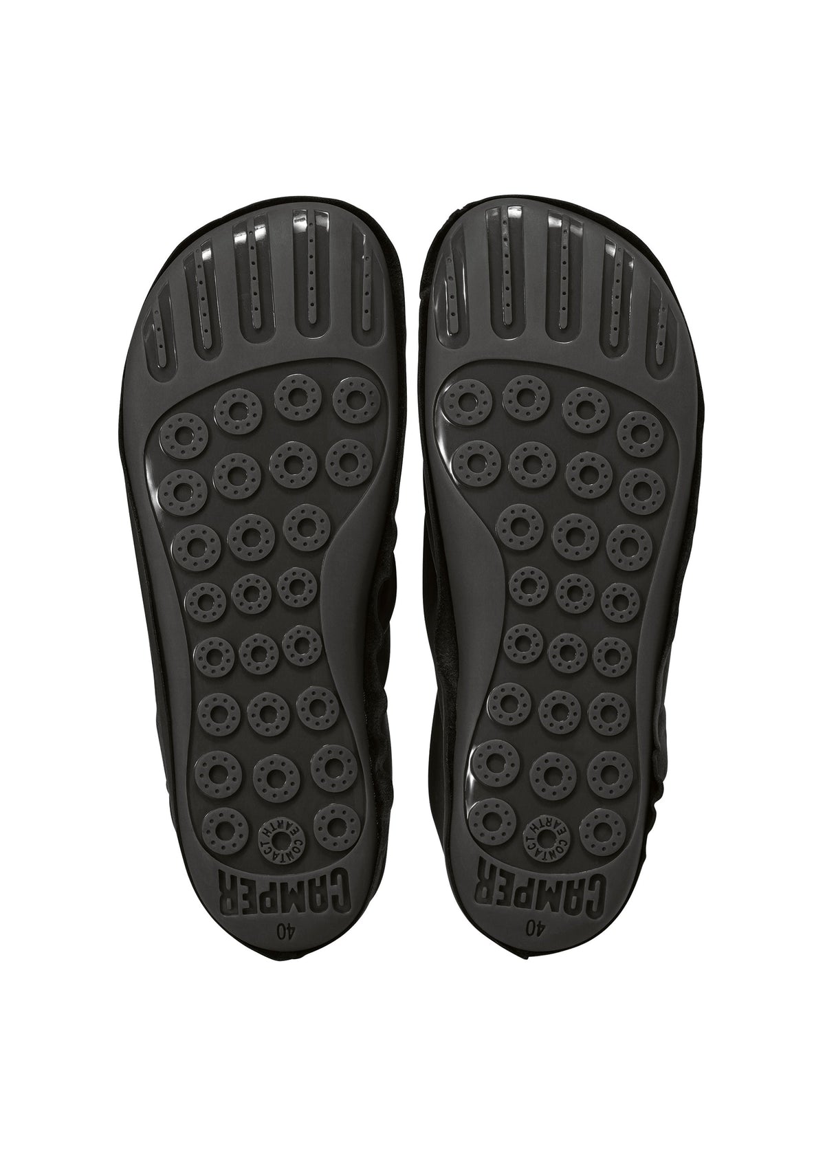 The image shows the black soles of a pair of ISSEY MIYAKE PEU FORM shoes, featuring circular textured grips and the word “CAMPER” embossed near the heel on each sole, reflecting the distinctive Peu Form design. view 7 of 8