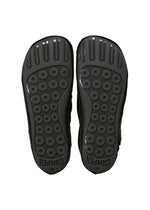 The image shows the black soles of a pair of ISSEY MIYAKE PEU FORM shoes, featuring circular textured grips and the word “CAMPER” embossed near the heel on each sole, reflecting the distinctive Peu Form design.