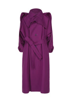 The CALLIGRAPH coat by ISSEY MIYAKE is a premium wool trench in a rich purple shade, featuring a belted waist, double-breasted buttons, wide collar, and puffed shoulders. Part of the Autumn Winter 2026/27 Collection, it is displayed against a white background. - PURPLE （no.81）