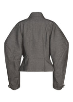 The REFLECTION jacket by ISSEY MIYAKE is a gray tailored design featuring wide, structured shoulders and long sleeves, shown from the back. Reminiscent of a sleek silver piece, it boasts a fitted waist and buttoned cuffs.