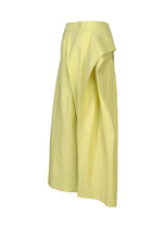 The GRAINY PANTS by ISSEY MIYAKE are wide-leg, high-waisted yellow jacquard pants featuring a connected waistband and an asymmetrical layered side panel, shown on a plain white background.