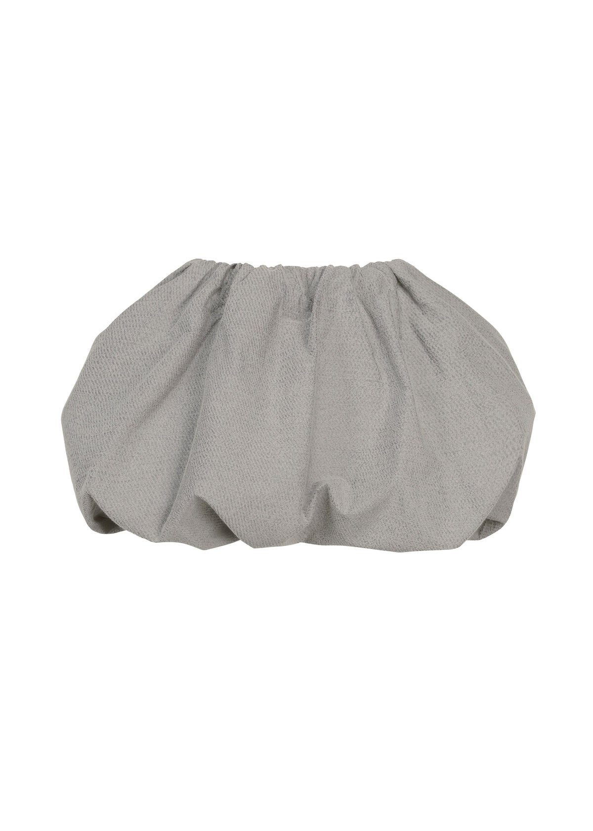 ISSEY MIYAKE’s REFLECTION scrunchie features soft reflector fabric in gray, creating a gathered, ruffled design with a subtle shine and contemporary edge, photographed on a plain white background. view 1 of 8