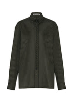 The MONSIEUR SHIRT (DOBBY STRIPE) by ISSEY MIYAKE features a dark green cotton yarn-dyed fabric with fine vertical white dobby stripes. It includes long sleeves, a collared neckline, button front closure, and a distinctive black drawstring at the neck reminiscent of a bolo tie. The ISSEY MIYAKE brand label is visible inside the collar. - BLACK-HUED （no.17）