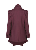 A back view of the ISSEY MIYAKE MANNER maroon blazer, made from upcycled fabric, with long sleeves, buttoned cuffs, and an extended back hem for a stylish take on sustainable fashion.