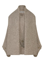 The WOOLEN GRANITE by ISSEY MIYAKE is a light brown merino wool cape featuring wide lapels, side button details, and a soft, textured fabric with the brand label at the neck. - BEIGE （no.41）