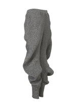 The ISSEY MIYAKE FOUND STONE pants feature a gray stone knit, mesh-like pattern, baggy fit, and gathered ankle cuffs, shown on a white background.