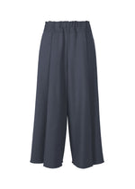 The CAMPAGNE pants by ISSEY MIYAKE feature a wide-leg culotte silhouette in navy, crafted from slightly textured A-POC material. Designed with a high, elastic waistband, these pants have loose, flowing legs and unfinished hems for an effortlessly chic look. - DARK NAVY （no.78）
