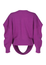 The O KNIT by ISSEY MIYAKE is a purple, round-neck 100% wool top with long sleeves and a distinctive curved cutout at the back hem.