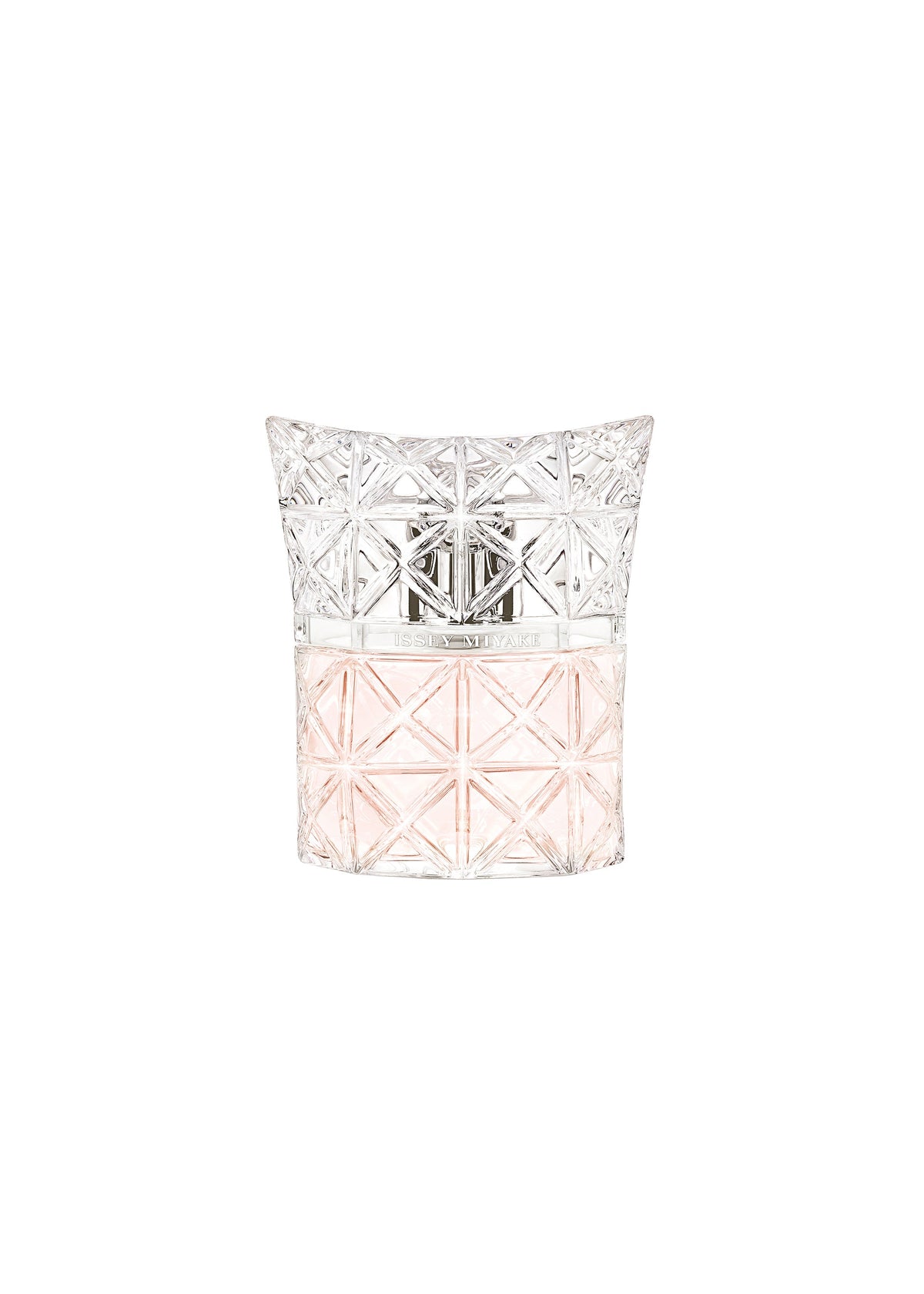 A clear glass ISSEY MIYAKE PARFUMS bottle with geometric patterns, half-filled with light pink LUMIERE D’ISSEY EAU DE PARFUM, features a silver emblem and a faceted transparent cap. view 1 of 3
