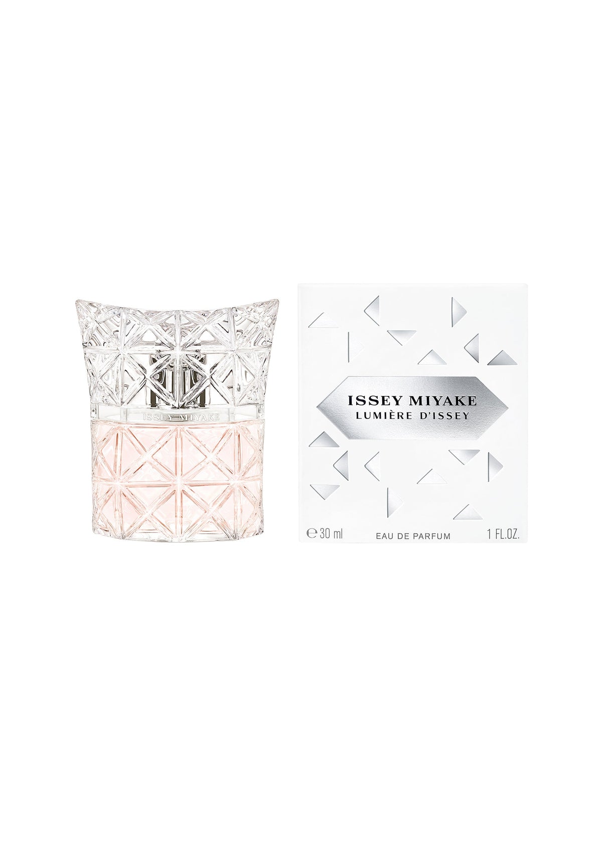 A bottle of LUMIERE D’ISSEY EAU DE PARFUM by ISSEY MIYAKE PARFUMS, featuring pale pink liquid in a geometric, textured glass design, sits beside its white box decorated with metallic triangular patterns. view 2 of 3