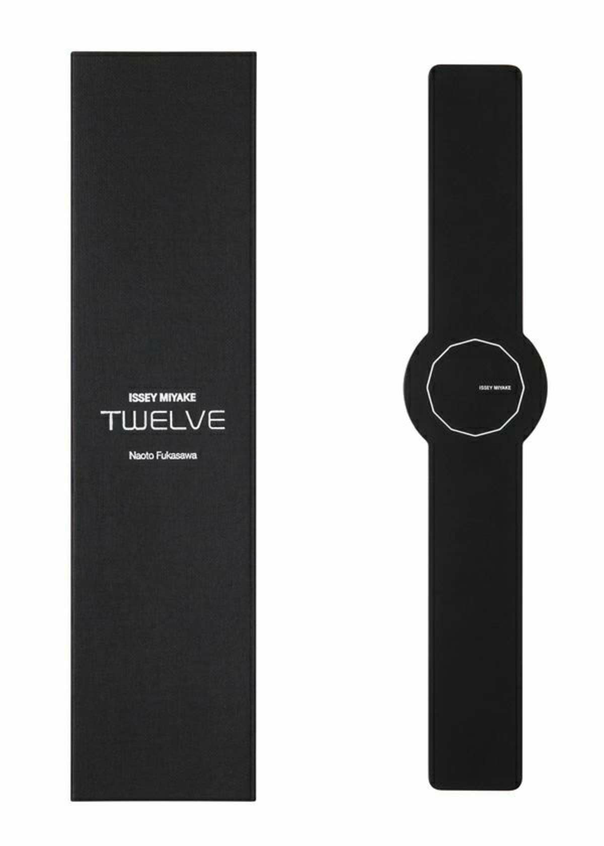Zoomed view A minimalist black ISSEY MIYAKE WATCH from the TWELVE collection, designed by Naoto Fukasawa, with a numberless round face, sits beside its rectangular black box labeled ISSEY MIYAKE WATCH TWELVE Designed by Naoto Fukasawa.