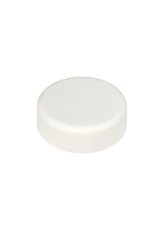 A single round, white tablet with a smooth surface and subtle, indented text rests on a plain white background—its minimalist aesthetic reflecting the refined design sensibility of Tokujin Yoshioka, as seen in the O watch for ISSEY MIYAKE WATCH.