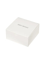 A plain white square box with ISSEY MIYAKE WATCH printed in gray uppercase letters on the lid. Designed with a simple, minimalist aesthetic and set against a white background, the box perfectly embodies the iconic style of Tokujin Yoshioka—the designer behind “O” by ISSEY MIYAKE WATCH, as well as the brand’s renowned lightweight bangle watch and transparent watch collections.