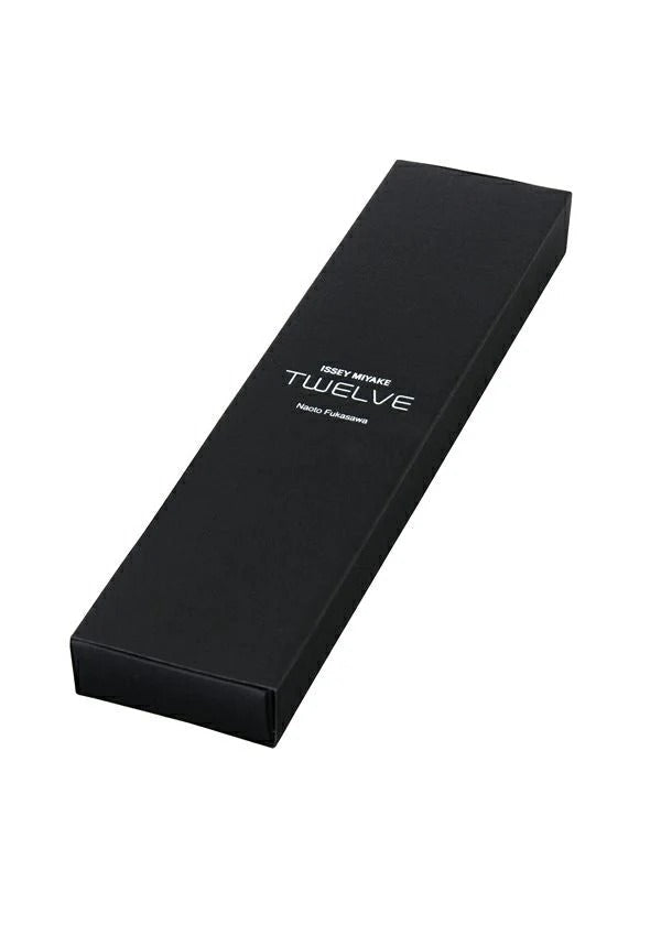 A black rectangular box with “TWELVE” in white on the lid and smaller text, from the ISSEY MIYAKE WATCH TWELVE series designed by Naoto Fukasawa, shown closed on a plain white background. view 5 of 7