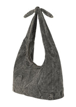 The ELEMENTS BAG by IM MEN is a black, acid-washed denim shoulder bag with flame-shaped stitching and a knotted top handle, offering standout style in textured cotton.