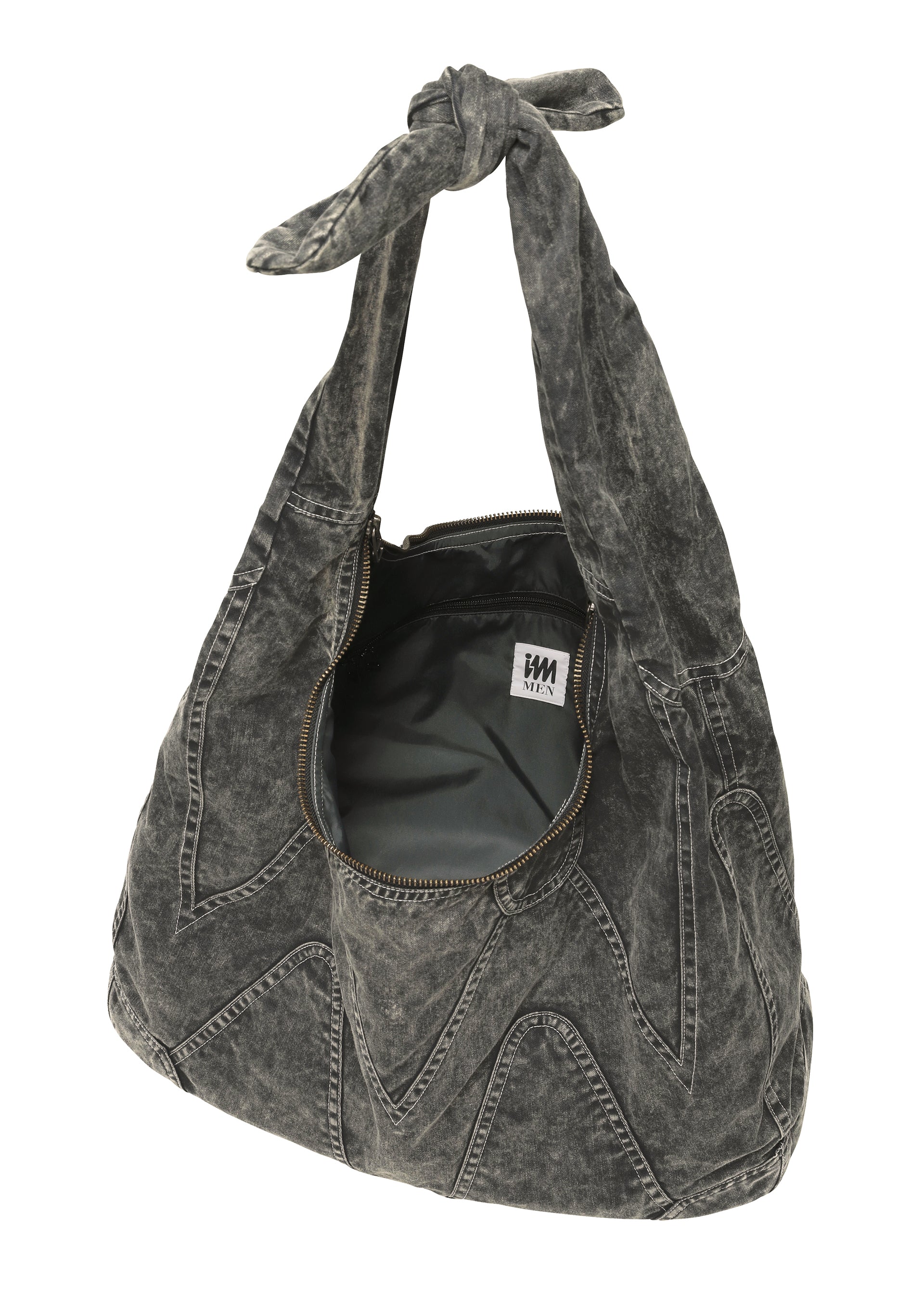 Zoomed view The ELEMENTS BAG by IM MEN is a slouchy, black acid-wash denim shoulder bag with a knotted handle, zigzag stitching, an open zipper, and a visible inner label—offering ceramic-inspired, artisanal flair.