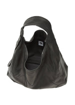 The ELEMENTS LEATHER BAG by IM MEN is a large black luxury leather bag with a wide handle, open zipper showing a spacious interior, visible white tag with black writing inside, and an adjustable shoulder strap for versatility.