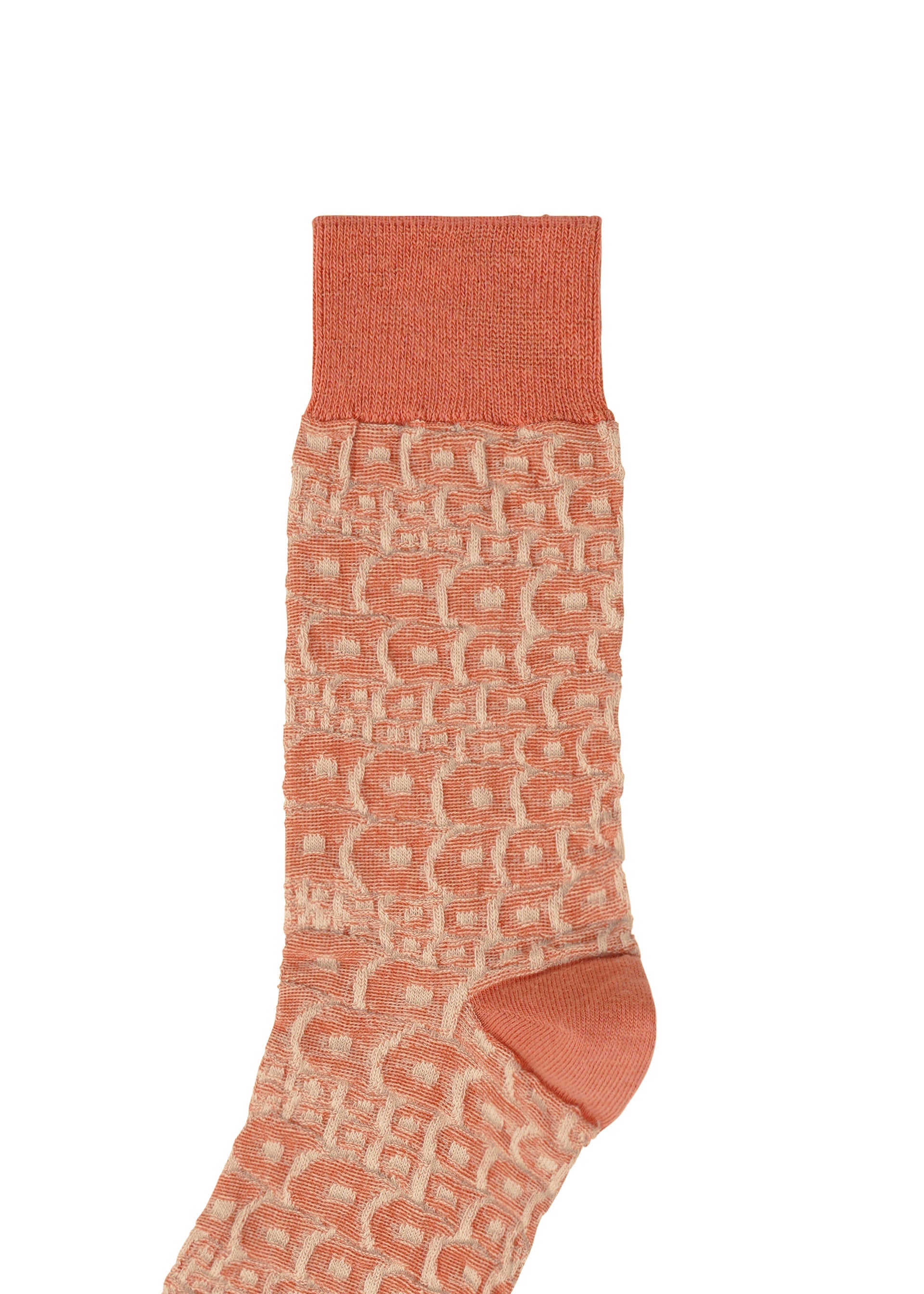 Zoomed view A single peach-colored UROKOMON SOCK by IM MEN features a textured geometric pattern with solid cuff, heel, and toe, displayed on a white background.