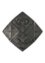 The GINTO FLAT by IM MEN features geometric, diamond origami forms in metallic gray, with symmetrical lines and layered patterns that echo the structured elegance of a silver foil jacket.