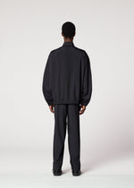 A person with short hair faces away from the camera, wearing IM MEN’s AIR PLEATS lightweight black jacket and matching pants designed for freedom of movement, set against a plain white background.