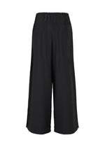 IM MEN's WAFT BLACK wide-leg culotte pants feature an elastic waistband, subtle pleats, and small side slits at the mid-calf hem. Shown from the back against a white background, they're crafted in wrinkle-resistant, linen-like fabric.