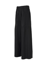 The IM MEN WAFT BLACK culotte pants feature a linen-like texture, elastic waistband, loose fit, and mid-calf length, shown on a white background.