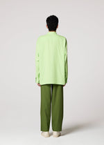 A person stands facing away from the camera wearing the IM MEN DOUBLE FACE COTTON SHIRT in light green, olive green pants, and beige shoes against a plain light background.