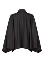 The IM MEN SWING BLACK jacket is a black, collarless kimono-style piece with wide, flowing sleeves shown from the back on a white background. This lightweight jacket provides a relaxed fit for effortless style.
