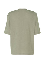 Back view of the IM MEN SHRINK STRETCH T, a plain light olive green T-shirt with short sleeves and a soft feel, laid flat on a white background. This relaxed fit tee has no visible patterns, logos, or embellishments.