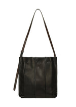 Introducing the LEATHER PLEATS by IM MEN—a classic black, natural leather shoulder bag designed with three vertical pleats, a long adjustable brown strap, and secure snap closures. Perfectly sized for a 13-inch laptop, it blends stylish versatility with practical functionality.