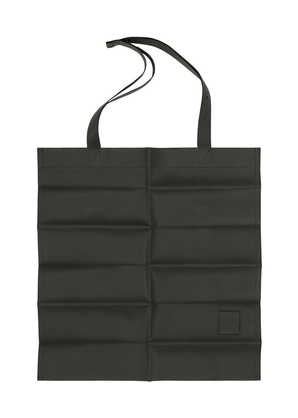 A black, rectangular foldable tote bag with two handles and a long strap is laid flat. The quilted fabric has a grid pattern and features a small stitched PATA PA patch by IM MEN near the bottom right corner. view 1 of 12