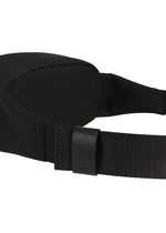 Close-up of a black adjustable strap with a plastic buckle, subtly embossed with the IM MEN logo, attached to the CUMMERBUND BAG—a compact black fabric accessory by IM MEN featuring hints of a cummerbund motif in its design.