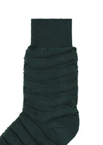 The IM MEN FORMAL WAVE SOCKS are dark green with a crinkled, ribbed design and raised horizontal lines. Featuring a gathered body and smooth cuff for comfort, they are shown on a plain white background.