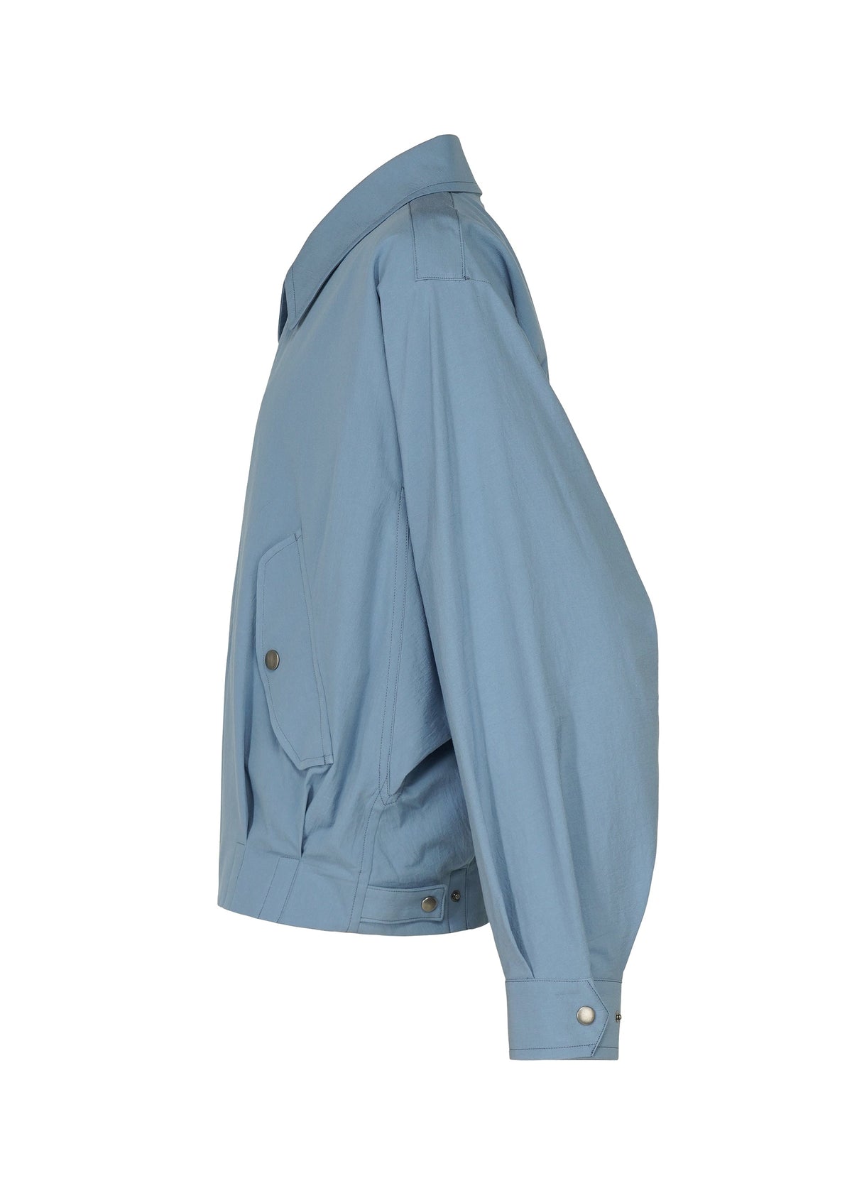 The COMFORT COTTON jacket by IM MEN is shown from the side in light blue. This long-sleeve organic cotton piece features a pointed collar, a side pocket with a buttoned flap, and buttoned cuffs and waistband. Crafted from high-twist cotton fabric, it has a slightly structured silhouette with a crisp texture and smooth finish. view 4 of 8