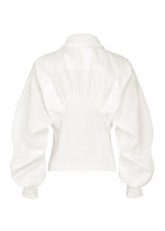 The CLAY blouse by IM MEN is a white long-sleeve top seen from the back, showcasing a high collar, ribbed waist, puffed sleeves, and ribbed cuffs that evoke the look of a rib knit jacket. The lightweight fabric is gently gathered at the waist for an elegant silhouette.