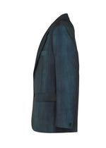 The IM MEN GRADATION WOOL jacket in dark teal worsted wool features a subtle gradient from a unique dye technique. Side profile on white, from the Autumn Winter 2026/27 collection.