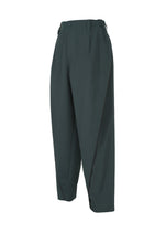 The FLUENT pants by IM MEN are dark green, high-waisted, wrinkle-resistant with pleats, side pockets, belt loops, and a relaxed tapered fit.