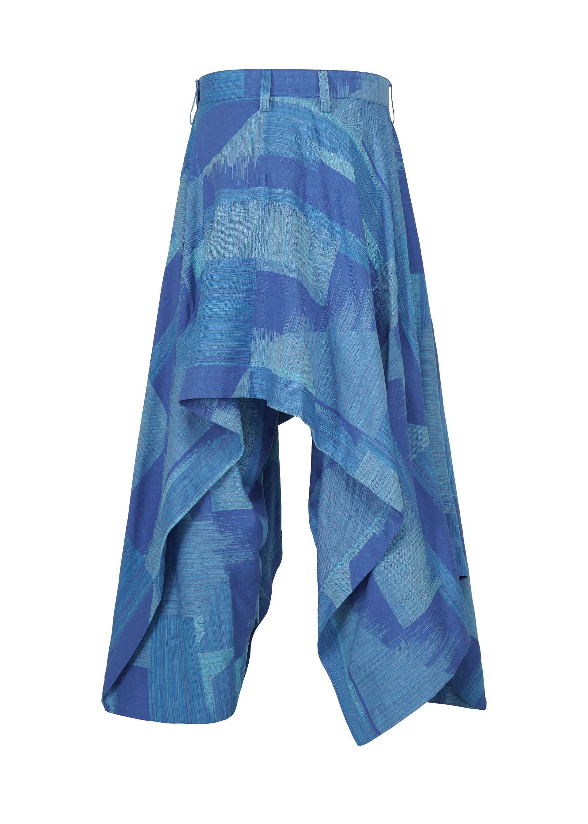 Zoomed view KASURI wide-leg pants or culottes by IM MEN, featuring a blue and teal pattern with an asymmetrical, draped design and pleats, displayed on a white background.