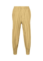 The EDGE pants by IM MEN are tan-colored and crafted from soft mélange polyester, featuring an elastic waistband, elasticized cuffs, and delicate hand-gathered pleated detailing. They are showcased against a plain white background. - BEIGE （no.41）