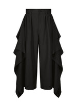 The BREEZE DRAPE pants from IM MEN feature a wide-leg silhouette with dramatic, layered fabric panels cascading from the sides for a distinctive and flowing look. These black pants offer a flat front with button and zipper closure, delivering a polished finish. - BLACK （no.15）