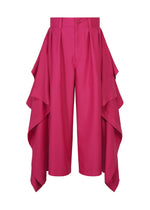 The BREEZE DRAPE pants by IM MEN feature a bold bright pink hue and dramatic, layered ruffle panels along each side, creating a stunning, flowing effect. These high-waisted flowy pants offer an effortlessly chic silhouette with their wide legs and secure button closure. - PINK （no.22）