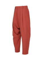 Loose-fitting, high-waisted COTTON YAK pants in vibrant red cotton from IM MEN, designed with pleats at the waist and a relaxed silhouette. These trousers feature tapered legs and are presented on a plain white background as part of the IM MEN Autumn Winter 2026/27 Collection.