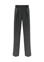 The DAWN RAY pants by IM MEN are black pleated trousers with a straight-leg fit, showcasing a pleated front and two vertical gray stripes along each side. They feature belt loops, a button closure, and offer a clean, modern design. - BLACK （no.15）