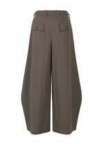 The OVERLAP culotte pants by IM MEN are wide-legged and high-waisted in olive green, crafted from a cotton-nylon blend with a natural texture. They feature two back flap pockets and belt loops, shown against a white background.