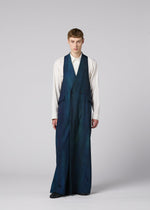 A person faces forward in a white shirt and blue GRADATION WOOL vest-pant by IM MEN, exemplifying Autumn Winter 2026/27 style against a plain light gray background.