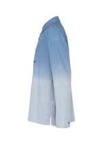 The DRIP SHIRT by IM MEN is a light blue cotton crepe shirt featuring a subtle gradient effect, long sleeves, and textured fabric, displayed from the side view against a plain white background.