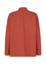 A back view of the IM MEN COTTON YAK long-sleeved shirt in rust highlights its collar, buttoned cuffs, and natural cotton yak texture against a white background.