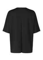 The IM MEN FLAT T is a plain black, loose-fit pressed T-shirt shown from the back, crafted from easy-care jersey with a straight hem for everyday comfort.